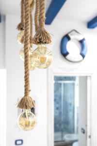 a group of glass globes hanging from a ceiling at Sea Elegance in Oliveri