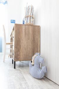a pair of striped socks sitting next to a cabinet at Sea Elegance in Oliveri