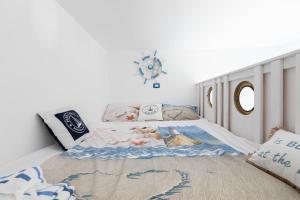 a bedroom with a bed with a blanket on it at Sea Elegance in Oliveri