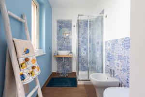 a bathroom with a shower and a toilet and a sink at Sea Elegance in Oliveri
