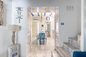 a hallway with a mirror and a dining room at Sea Elegance in Oliveri