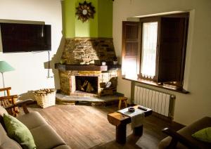 a living room with a couch and a fireplace at Casa da Lembranza in Fonsagrada