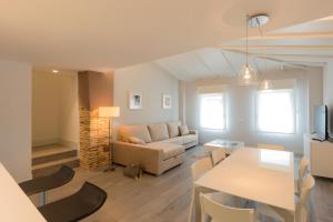 a living room with a couch and a table at APARTAMENTOS TURISTICOS - PAPEL ARMADO - Calle Caldereros 33 in Tudela