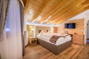 Postel nebo postele na pokoji v ubytování Hotel Ciamp