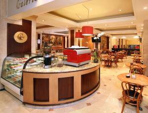 a food counter in a restaurant with tables and chairs at Emporio Reforma in Mexico City