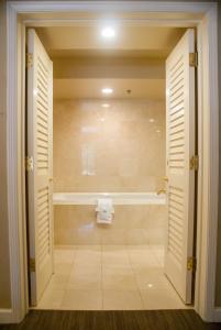 a bathroom with a shower and a bath tub at Indian Wells Resort Hotel in Indian Wells