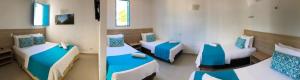 a room with two beds with blue and white at Hotel Aldea Plaza in Doradal +53 photos