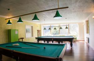 a living room with a pool table and lights at Vosku Ashxarh Hotel in Tsaghkadzor