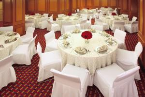 a banquet hall with white tables and white chairs at Emporio Reforma in Mexico City