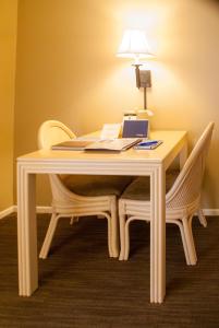 a white table with two chairs and a lamp on it at Indian Wells Resort Hotel in Indian Wells