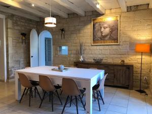 una cocina con una gran mesa blanca y sillas en Villa Donna jacuzzi jardin billard centre la Brèche, en Niort