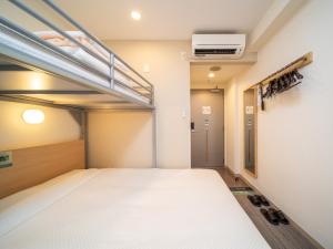 A bed or beds in a room at Super Hotel Asakusa