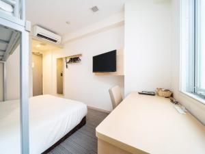 Postel nebo postele na pokoji v ubytování Super Hotel Asakusa