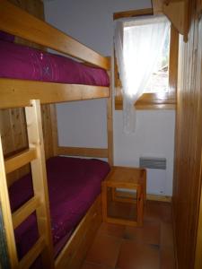 a small room with two bunk beds and a window at Le Panda in Les Carroz d'Araches