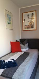a bedroom with a bed with a red pillow at Dorfstraße 21 Ferienwohnung 3 in Schwielowsee
