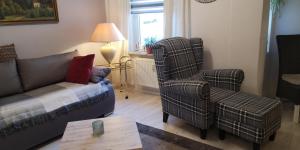 a living room with a couch and two chairs at Dorfstraße 21 Ferienwohnung 3 in Schwielowsee