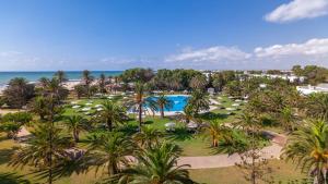 an aerial view of a resort with a pool and palm trees at OCEANA Hotel & Spa in Hammamet
