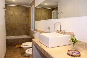 a bathroom with a sink and a toilet at Cabañas La Escondida in Tandil