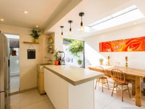 a kitchen with a table and a dining room at Regency Cottage in Brighton & Hove