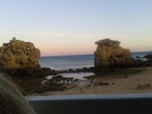 a view of a beach with rocks and the ocean at Tamatramas in Albufeira
