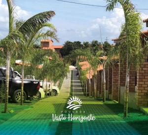 a street in a villa with palm trees at Pousada Vasto Horizonte in Barreirinhas