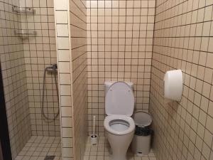 a bathroom stall with a toilet and a shower at Hotel Aura in Rostov on Don