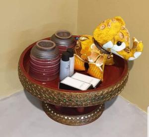 a bowl filled with items on a table at The Lantern Suites in Ban Song Hong