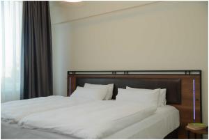 Ένα ή περισσότερα κρεβάτια σε δωμάτιο στο Motel Plus Schönefeld