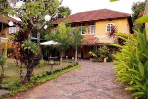 a house with a brick path in front of it at Tea Bungalow in Cochin