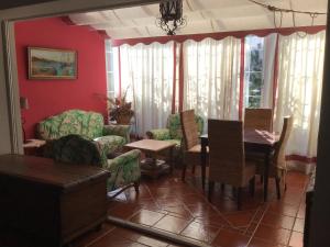 a living room with a table and chairs at Villa Rosario in Torre de Benagalbón