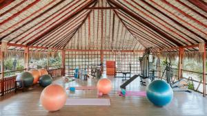 a gym with balls and exercise equipment in a tent at Araxá Pousada in Jericoacoara