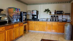 a large kitchen with wooden cabinets and appliances at FairBridge Inn Express Dillon in Dillon