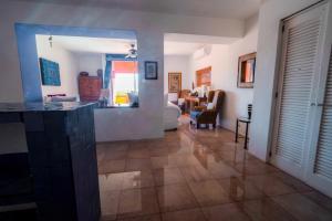 a large living room with a kitchen and a living room at Casa de los Sueños Hotel Boutique in Isla Mujeres