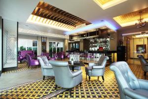 a restaurant with purple chairs and a bar at Chillax Resort - SHA Extra Plus in Bangkok