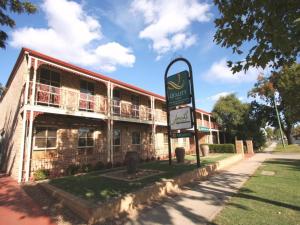 an old brick building with a sign in front of it at Quality Inn Colonial in Bendigo
