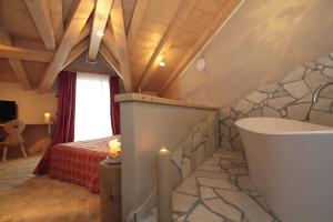 a bathroom with a bath tub in a room at Hotel Cristallo in Livigno