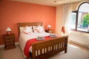 a bedroom with a bed with two stuffed animals on it at Kayden House in Killarney