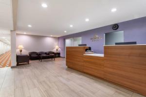 a lobby with a waiting room with chairs and a counter at Microtel Inn & Suites by Wyndham Philadelphia Airport in Philadelphia