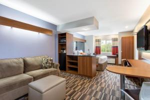 a living room with a couch and a table at Microtel Inn & Suites by Wyndham Philadelphia Airport in Philadelphia