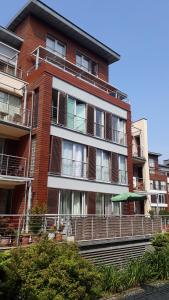 a tall brick building with balconies on the side of it at uMarka Zeta Park in Ustroń