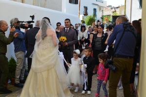 a bride and groom walking down the street at B&B Oliena in Oliena +43 photos