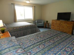 
A bed or beds in a room at C-Way Resort
