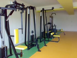 a gym with several tread machines in a room at Inventree hotels & Resort in Pune