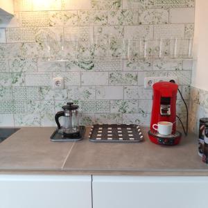 a red coffee maker sitting on top of a counter at Marktplatz Traunsee LAKE View in Gmunden