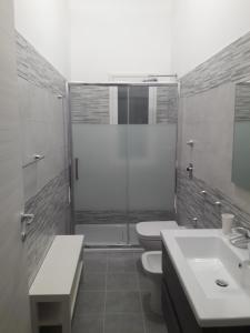 a bathroom with a shower and a toilet and a sink at Renda Apartments in Trapani