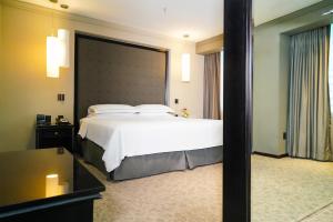 a bedroom with a large bed and a large window at Barceló Mexico Reforma in Mexico City