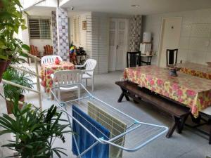 a living room with a table and a table and chairs at Cantinho Da Del in Recife