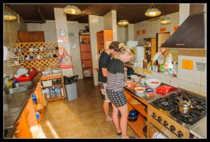 a group of people in a kitchen preparing food at Hospedaje Penthouse 1004 in San Carlos de Bariloche