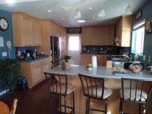 a kitchen with a island with bar stools in it at Engvadonia Yosemite B and B in Mariposa