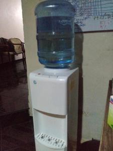a bottle of water sitting on top of a refrigerator at Casa Blanca Tu Casa in Santa Ana